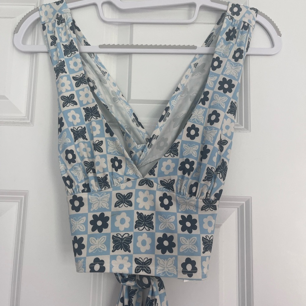 Blue and white patterned crop top with criss cross back.